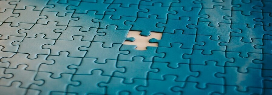 Blue jigsaw puzzle, with a missing piece in the center